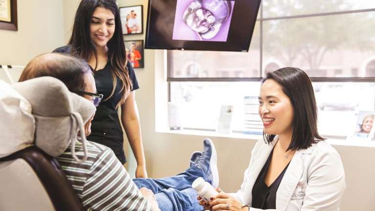 Dentist discussing wellness dentistry with patient